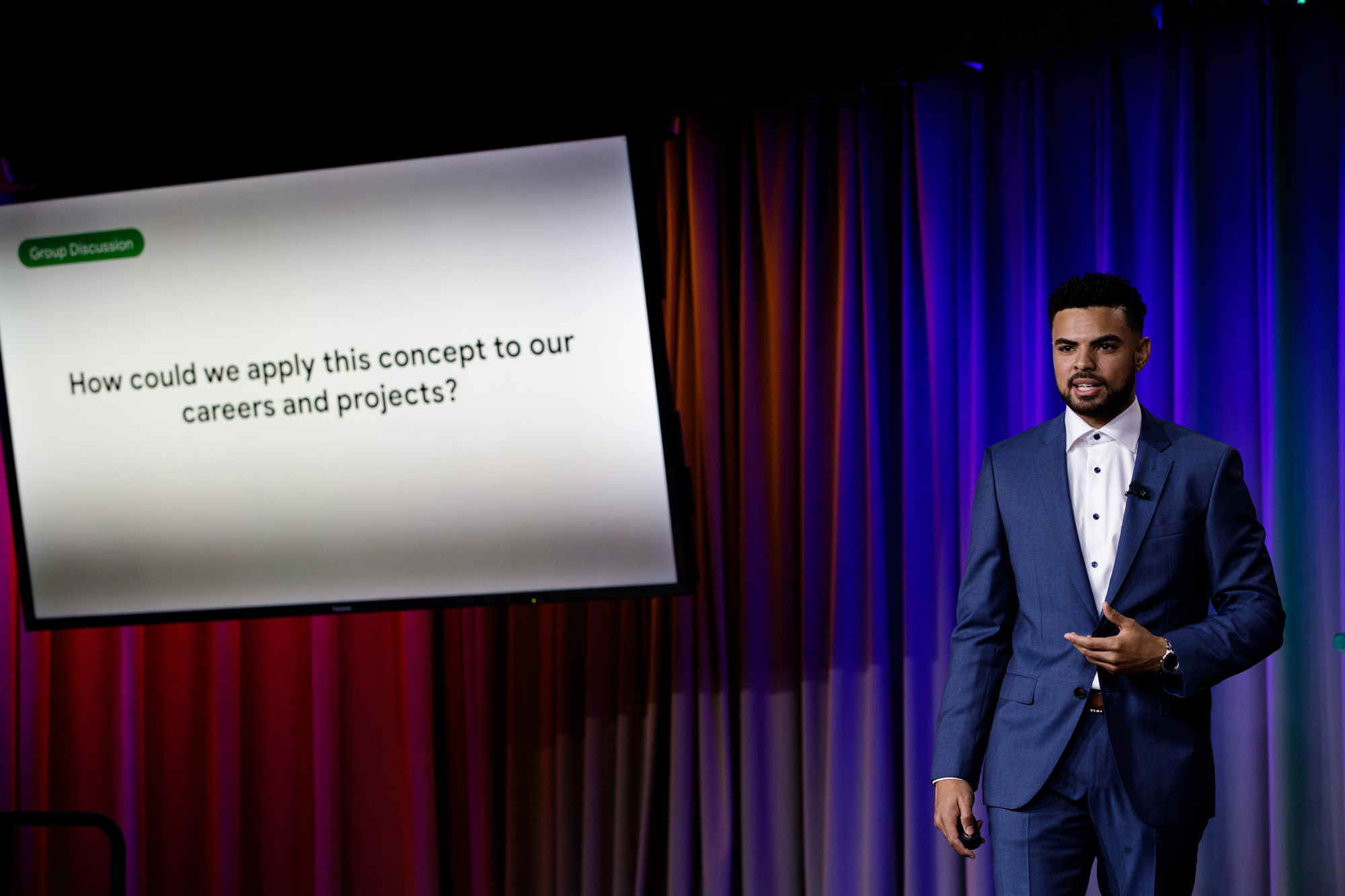 Kenton D. Raiford leading a group discussion on stage
